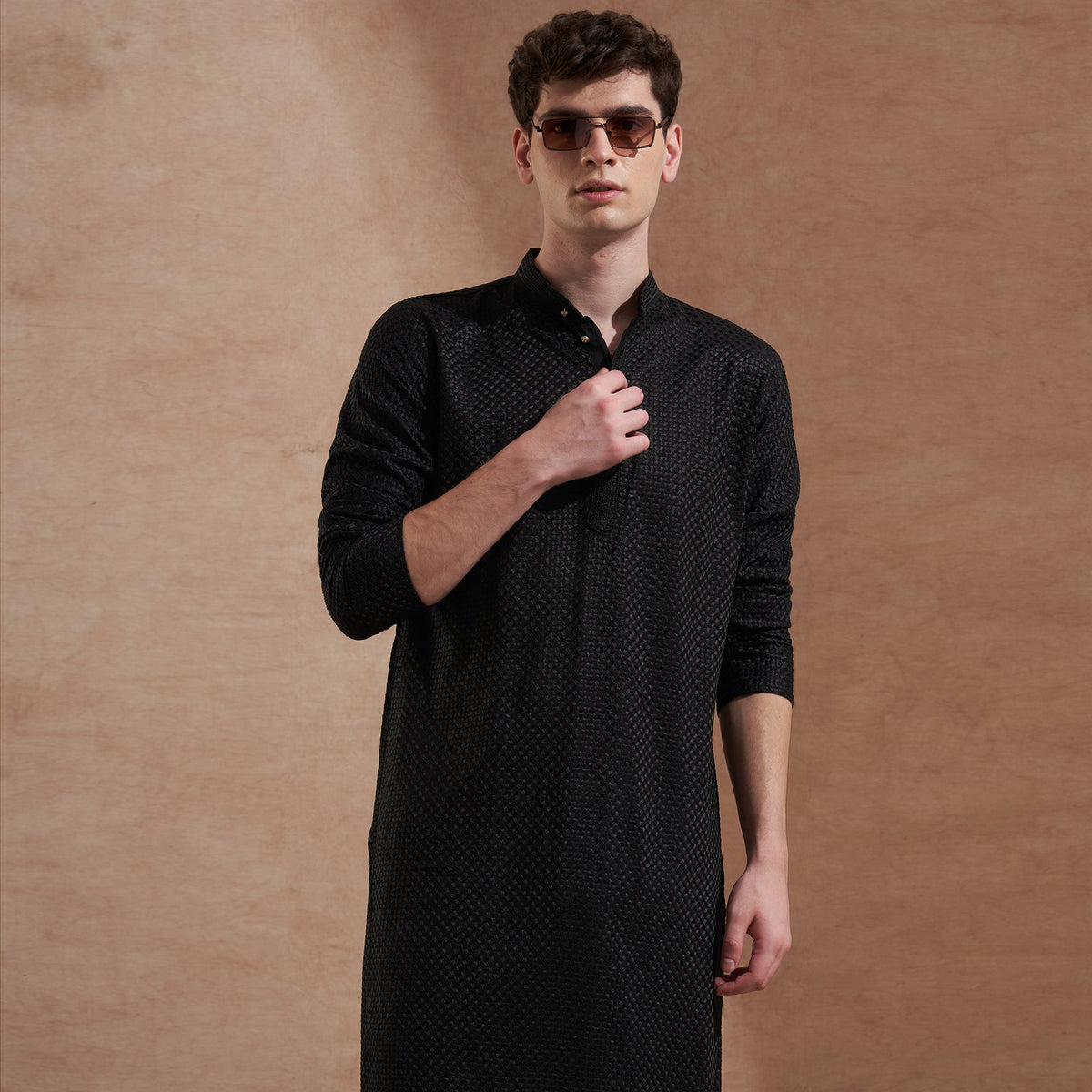 Men wearing a black tonal textured embroidered kurta for evening ethnicwear styling