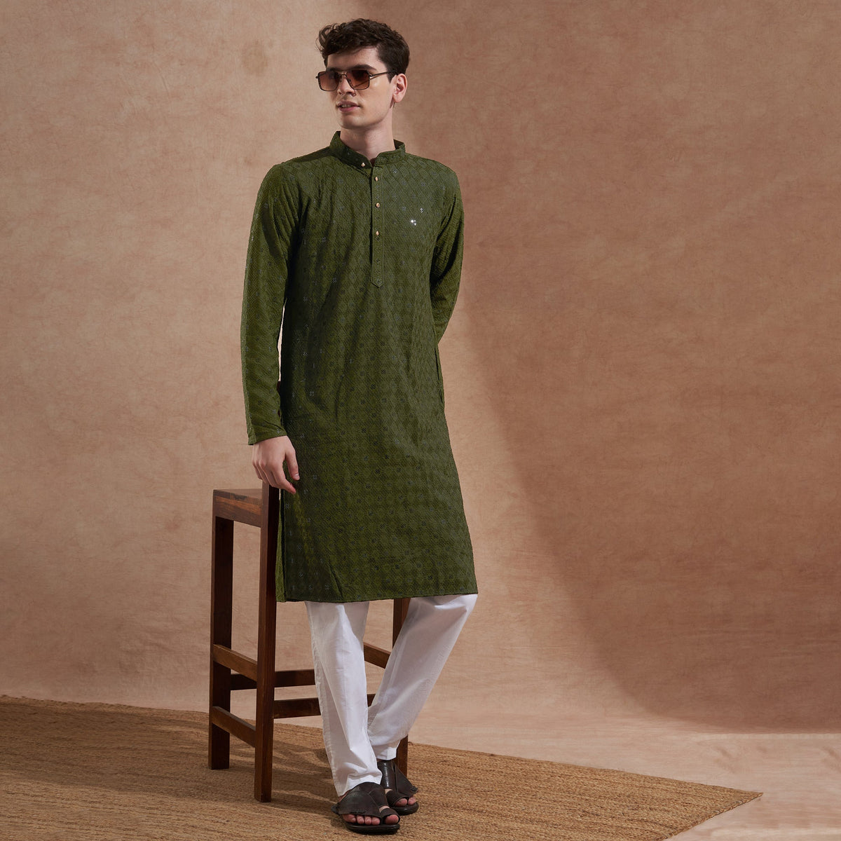 Man wearing an olive green embroidered kurta showing shoulder, sleeve, chest and overall length fit