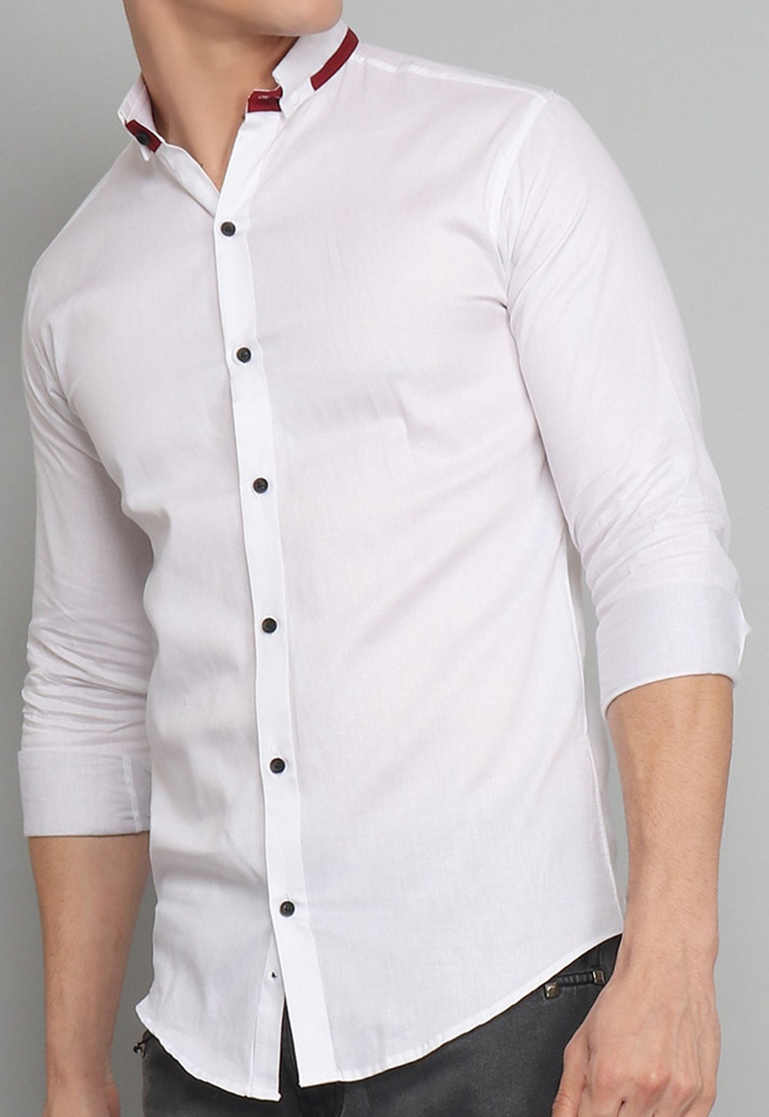 
a man wearing a white shirt and black pants
