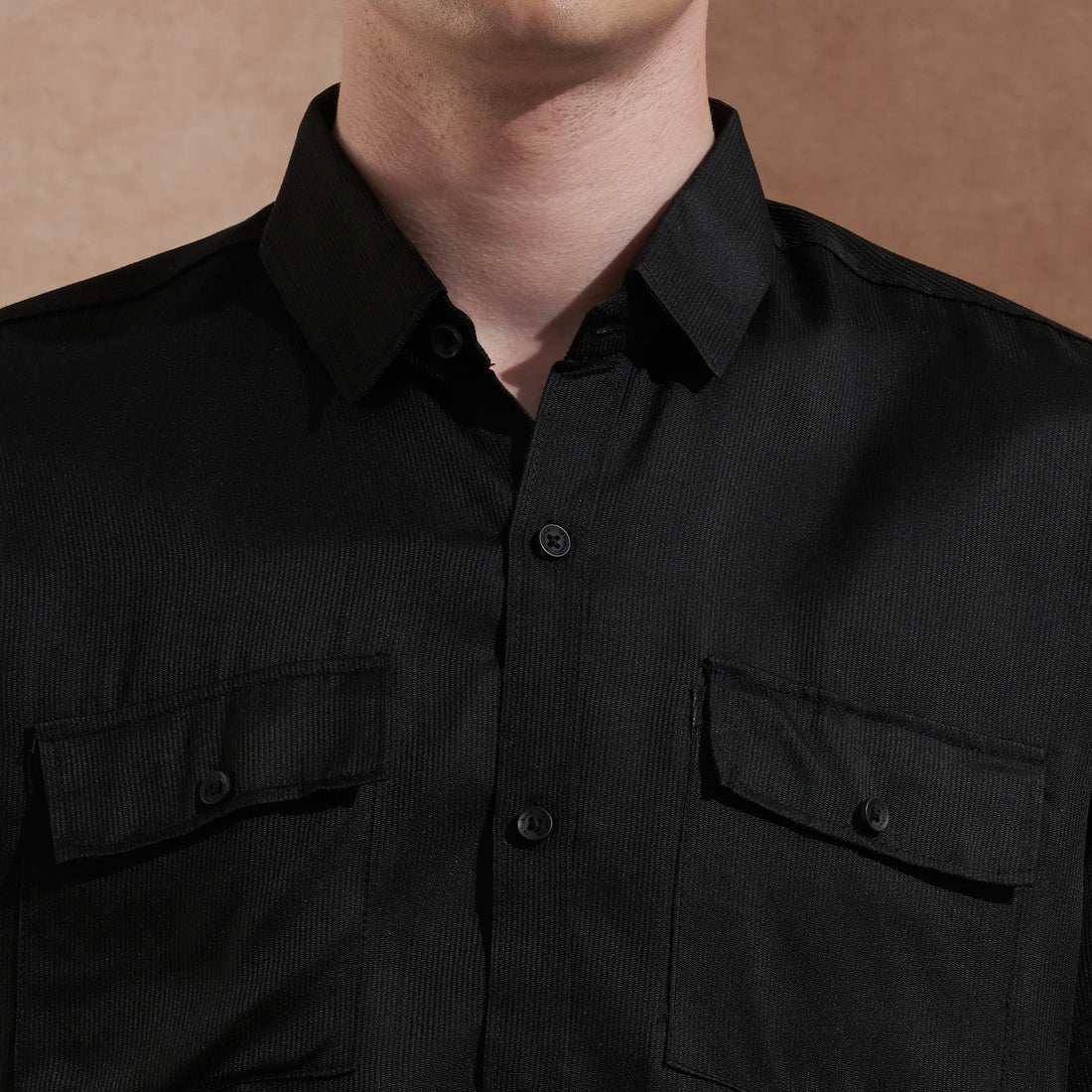 Men's black solid slim-fit shirt with dual flap pockets, product view