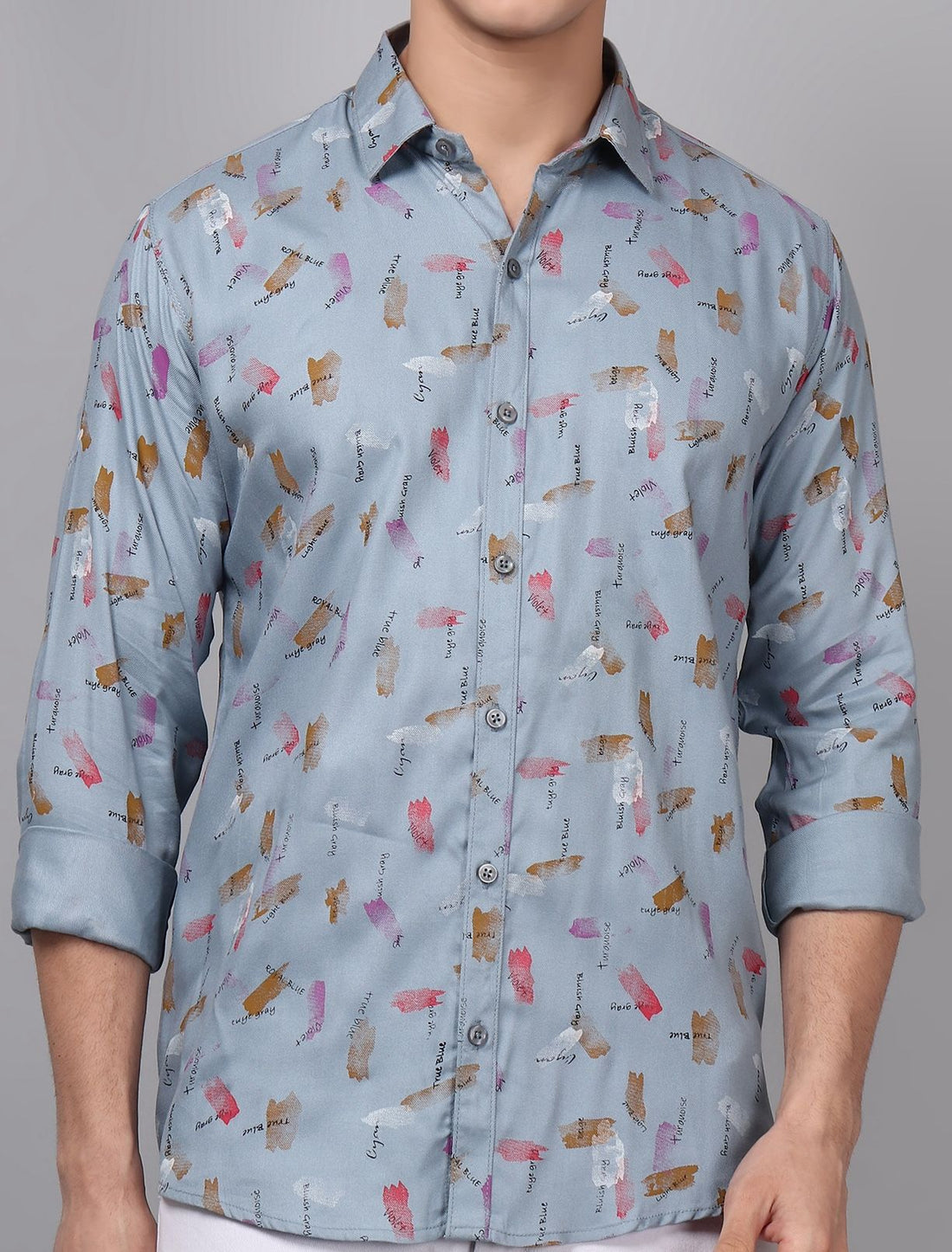 
a man wearing a blue shirt with a pattern on it
