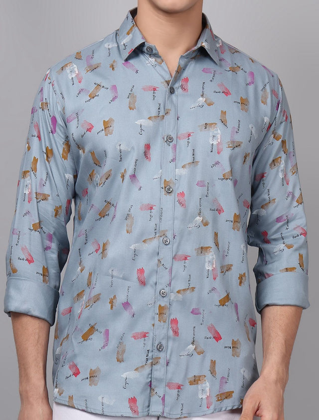 
a man wearing a blue shirt with a pattern on it
