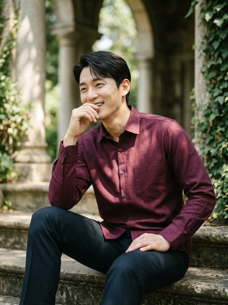 TRYBUY.IN TB_21190 men's burgundy cotton-linen shirt, relaxed seated view on stone steps with the front buttons and single chest pocket visible.