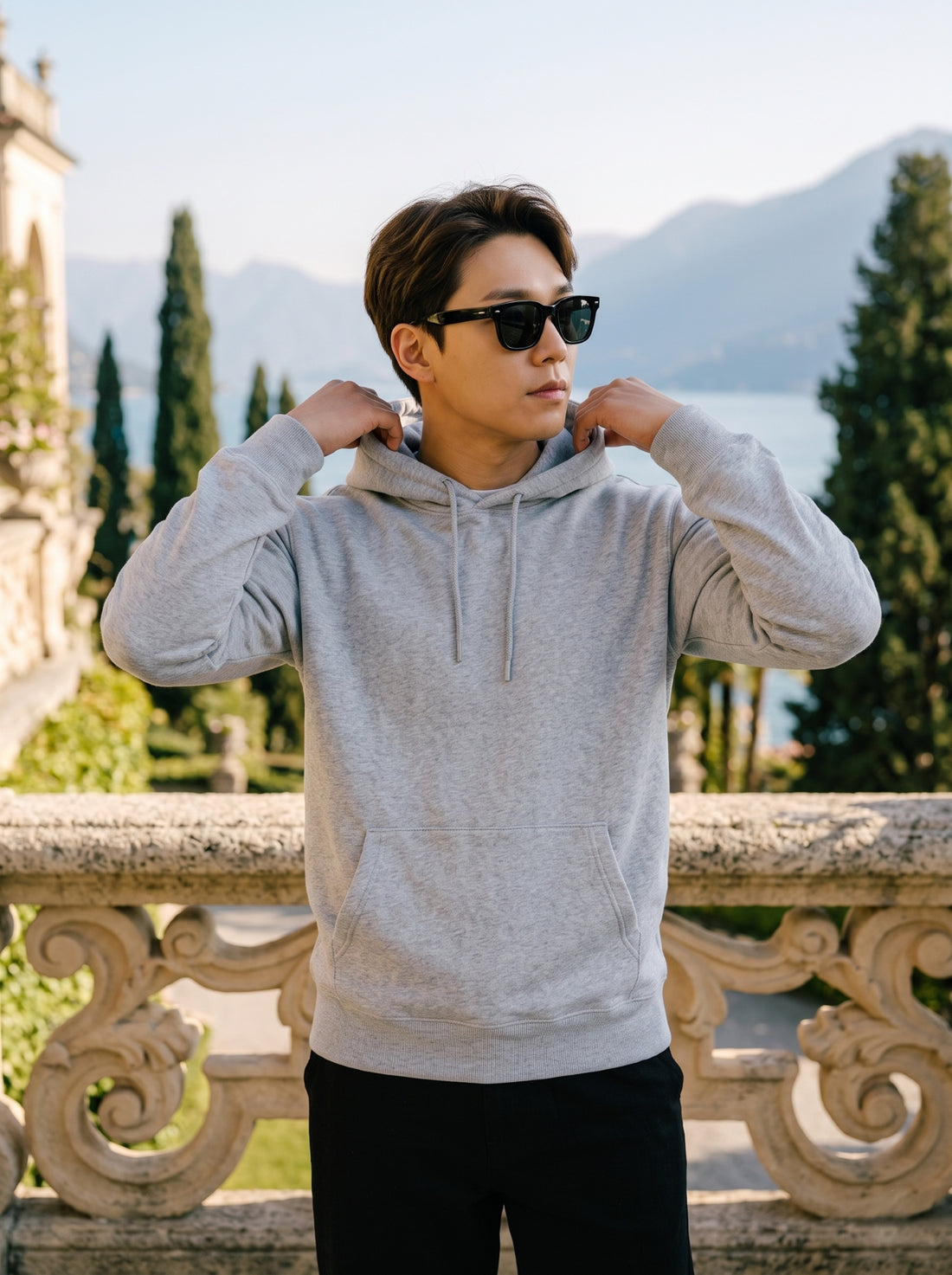 
Men's light grey cotton pullover hoodie, front hood detail lifestyle view
