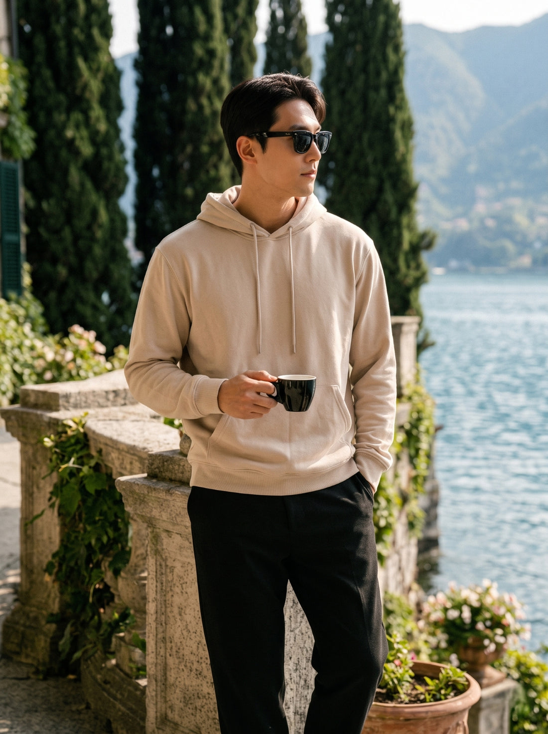 
Men's beige cotton pullover hoodie, front mid-length lifestyle view
