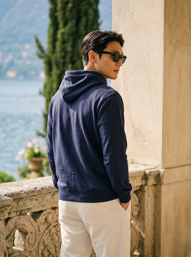 
Men's navy blue cotton pullover hoodie, rear three-quarter view
