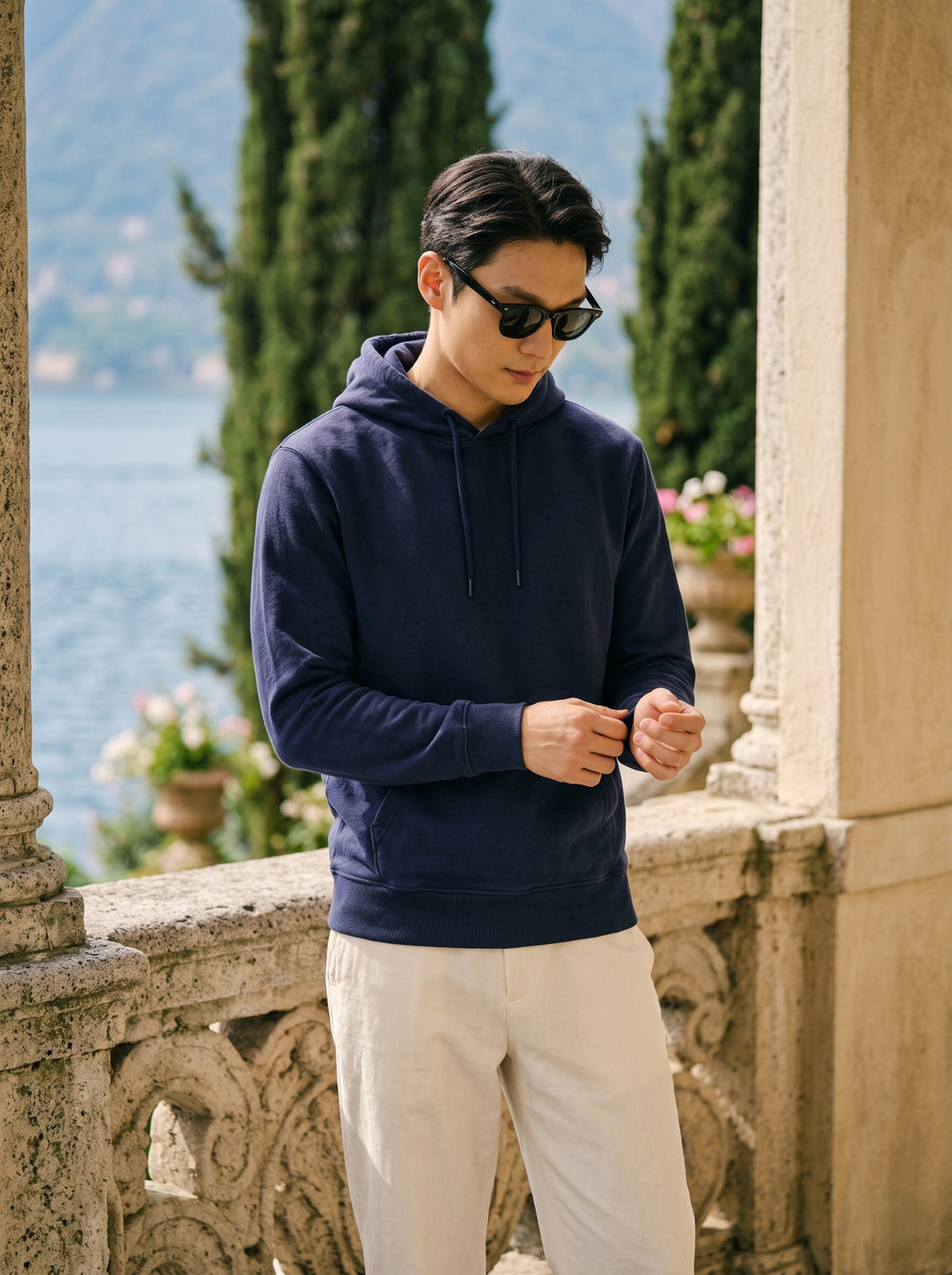 
Men's navy blue cotton pullover hoodie, front cuff detail lifestyle view
