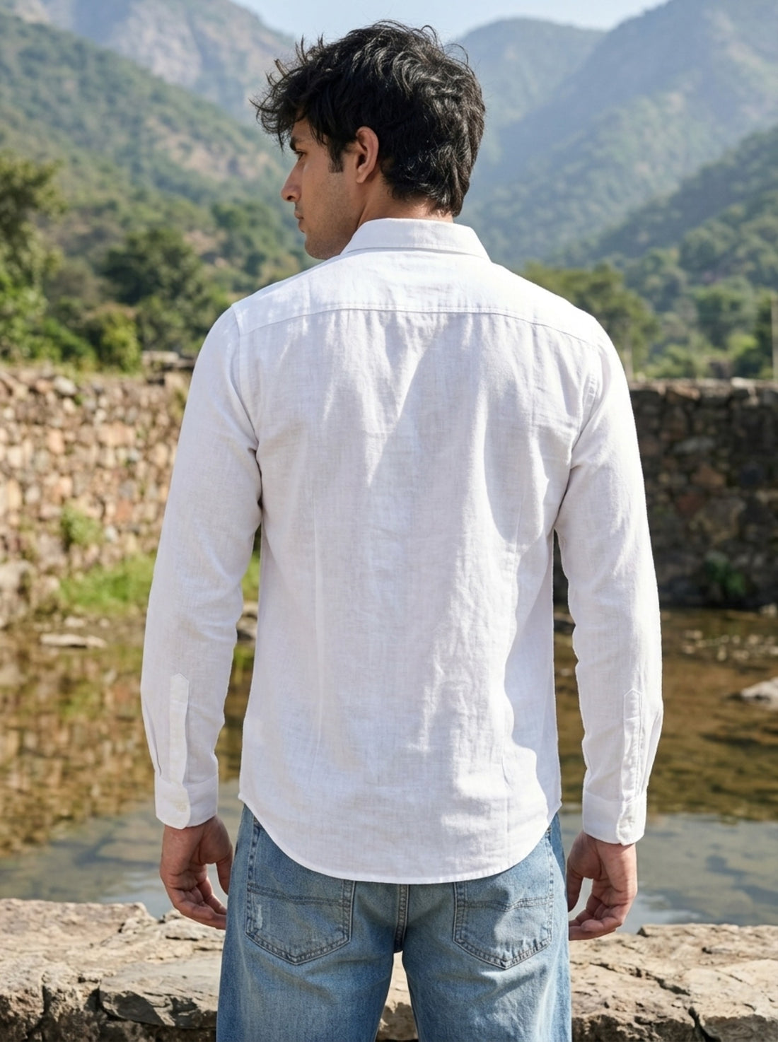 
Back of men's white linen shirt showing yoke and curved hem
