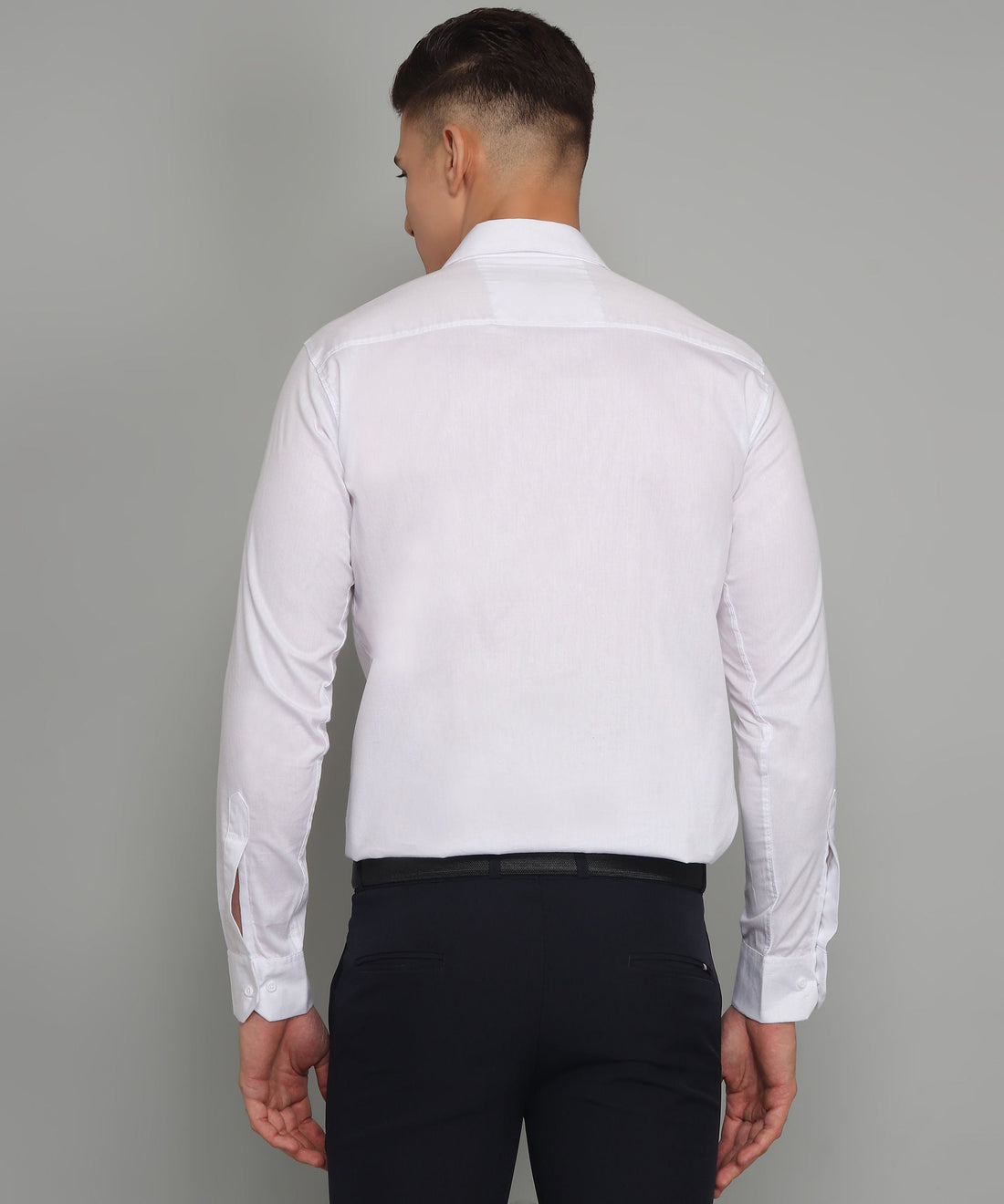
a man wearing a white shirt and black pants

