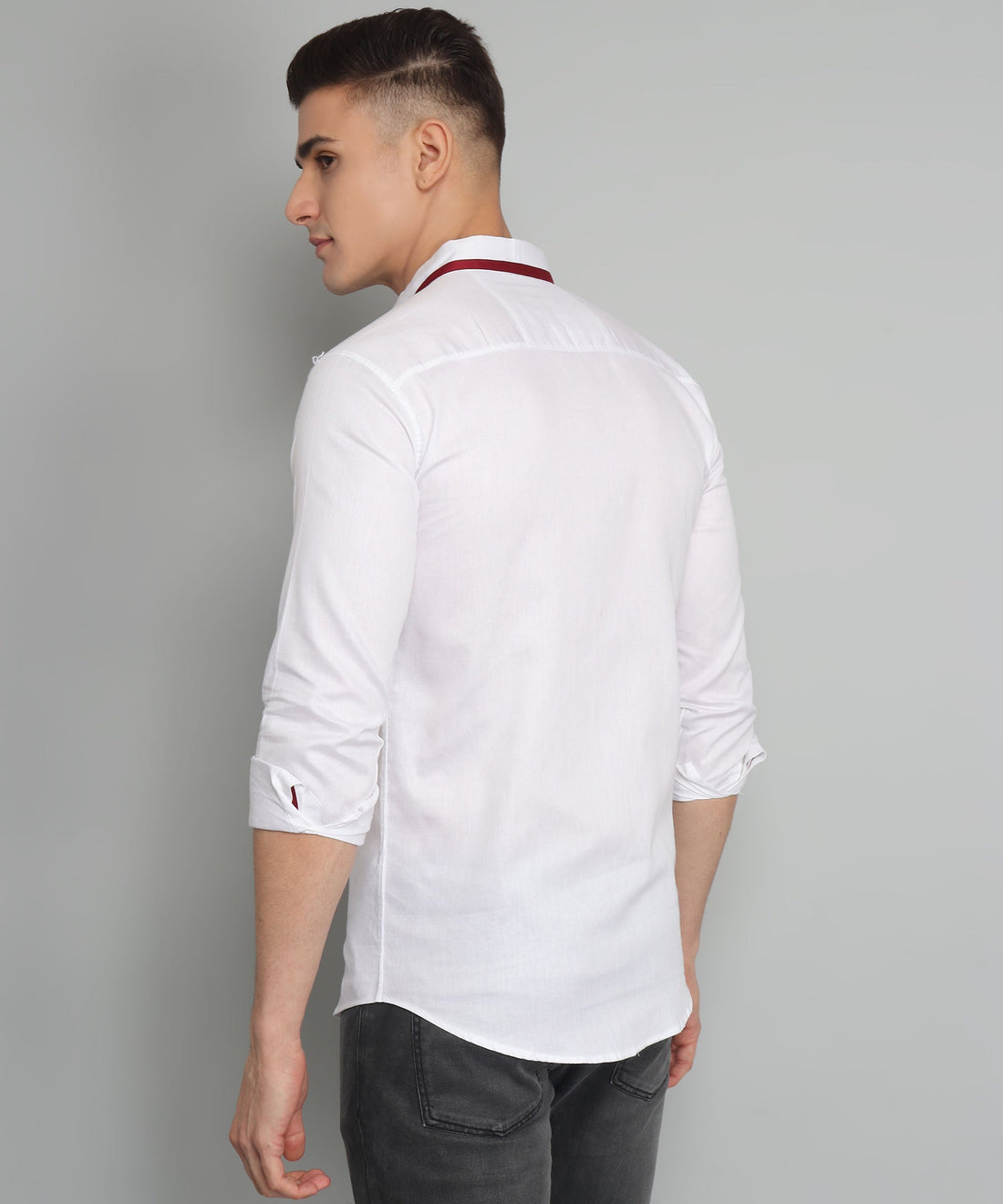 
a man wearing a white shirt and black pants
