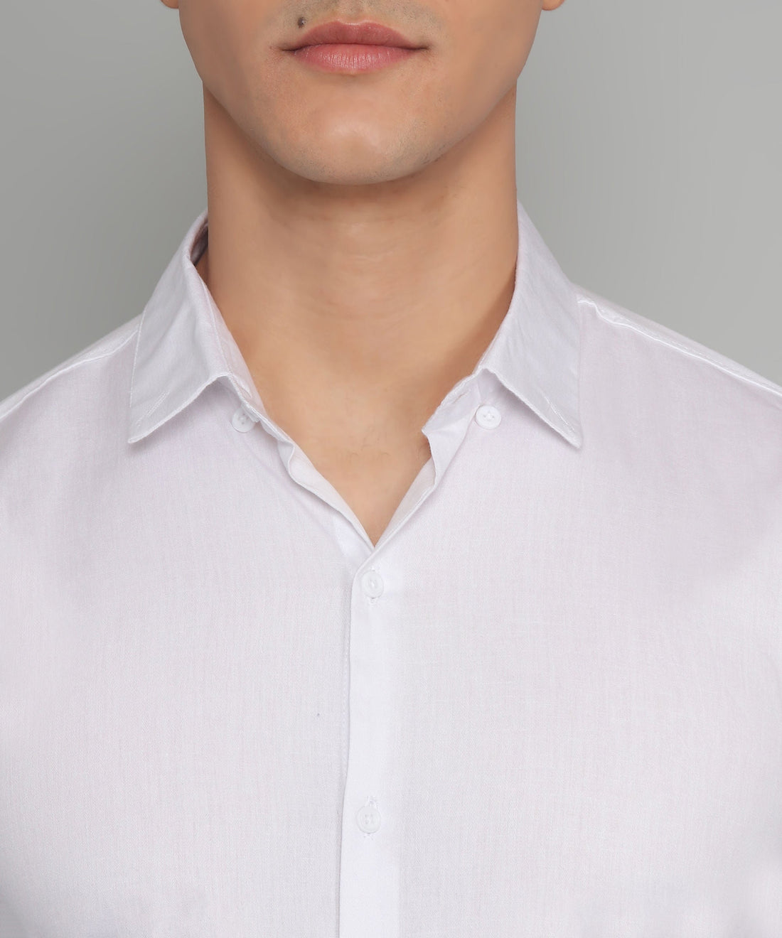 
a man wearing a white shirt and glasses
