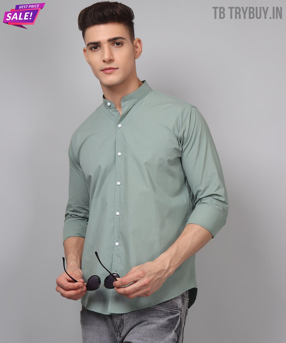a man in a green shirt is holding a pair of headphones