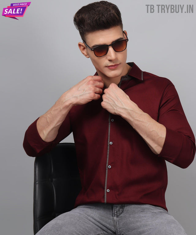 
a man sitting in a chair wearing sunglasses
