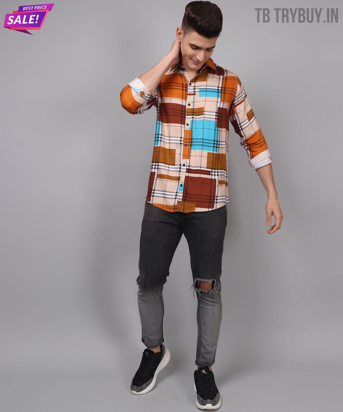 
a man in a plaid shirt and ripped jeans
