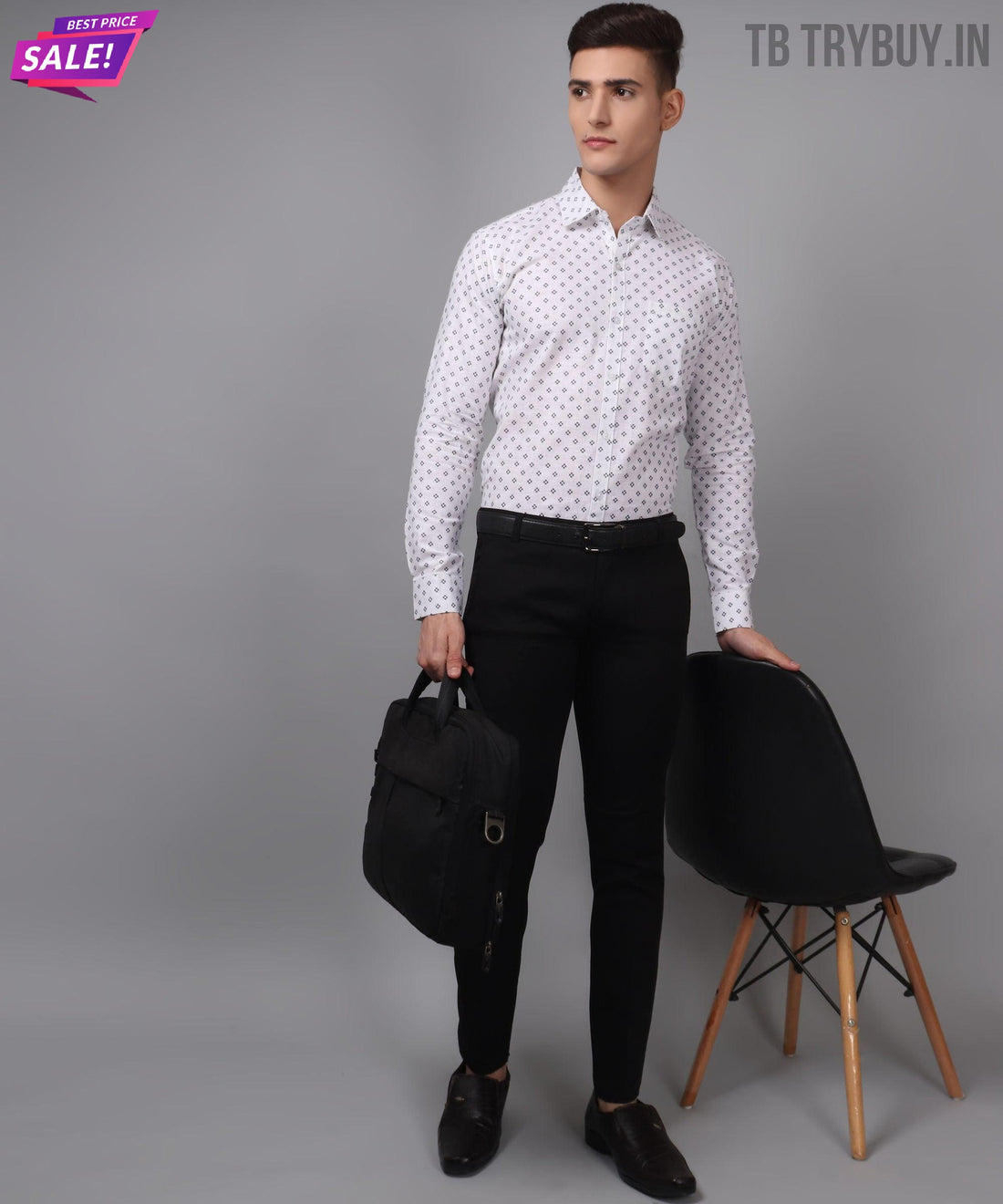 
a man standing next to a chair holding a bag
