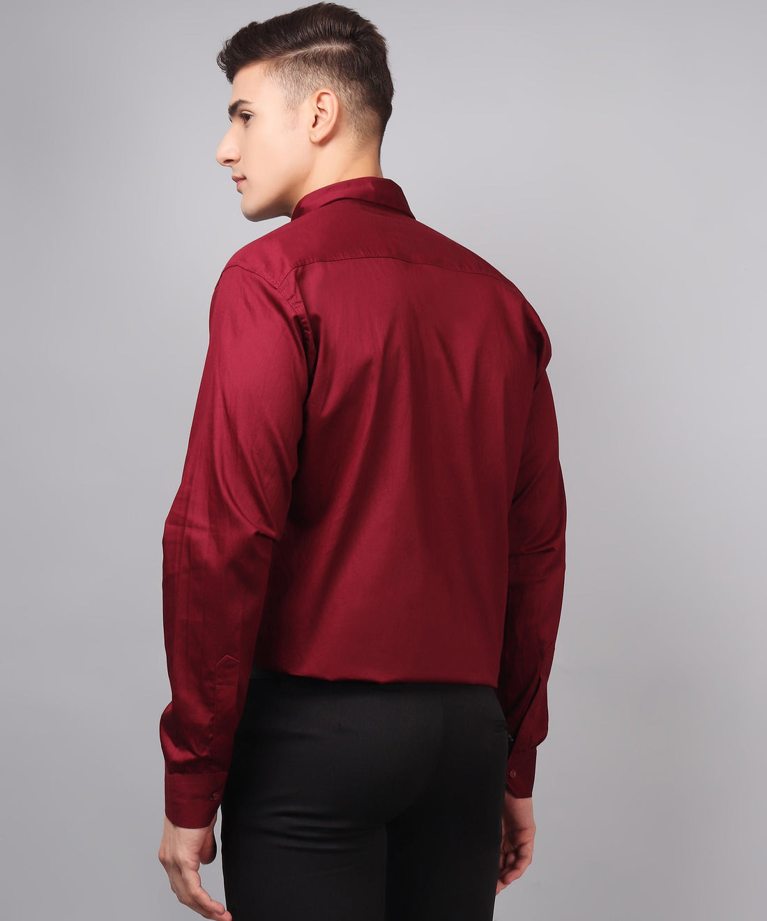 a man wearing a red shirt and black pants