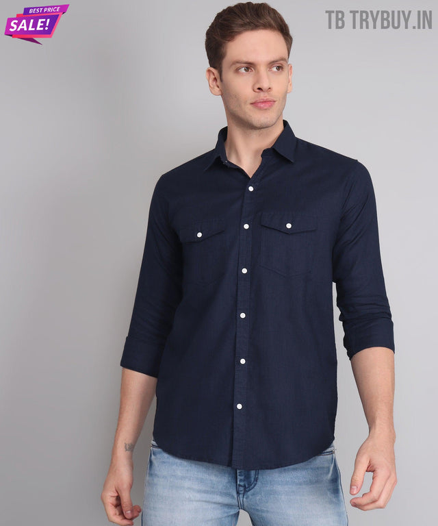 
a man wearing a blue shirt and jeans
