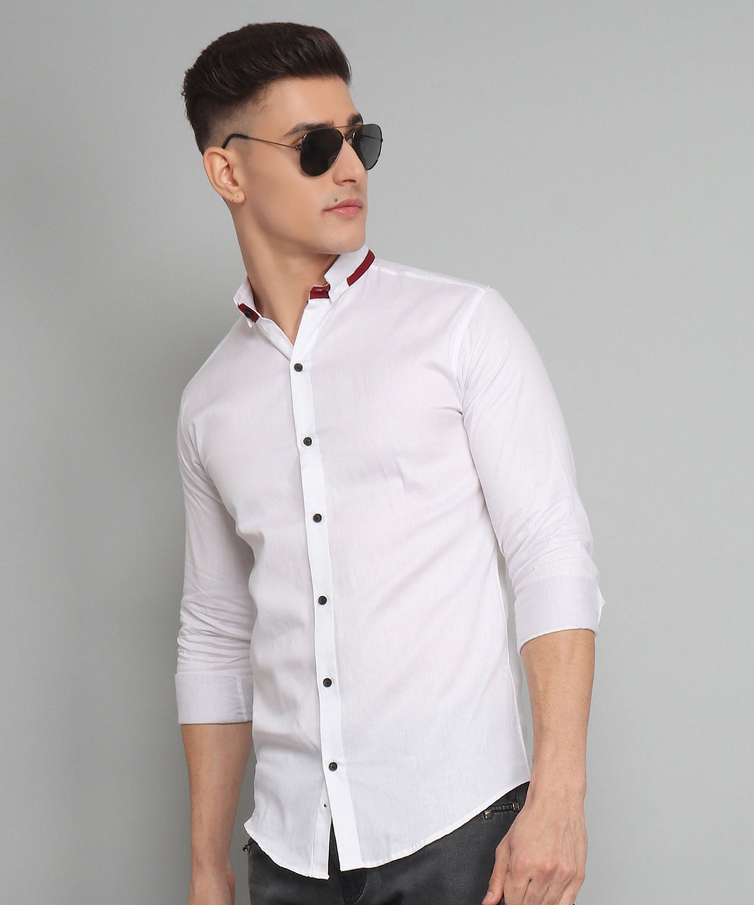
a man wearing sunglasses and a white shirt
