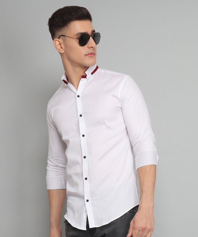 
a man wearing sunglasses and a white shirt
