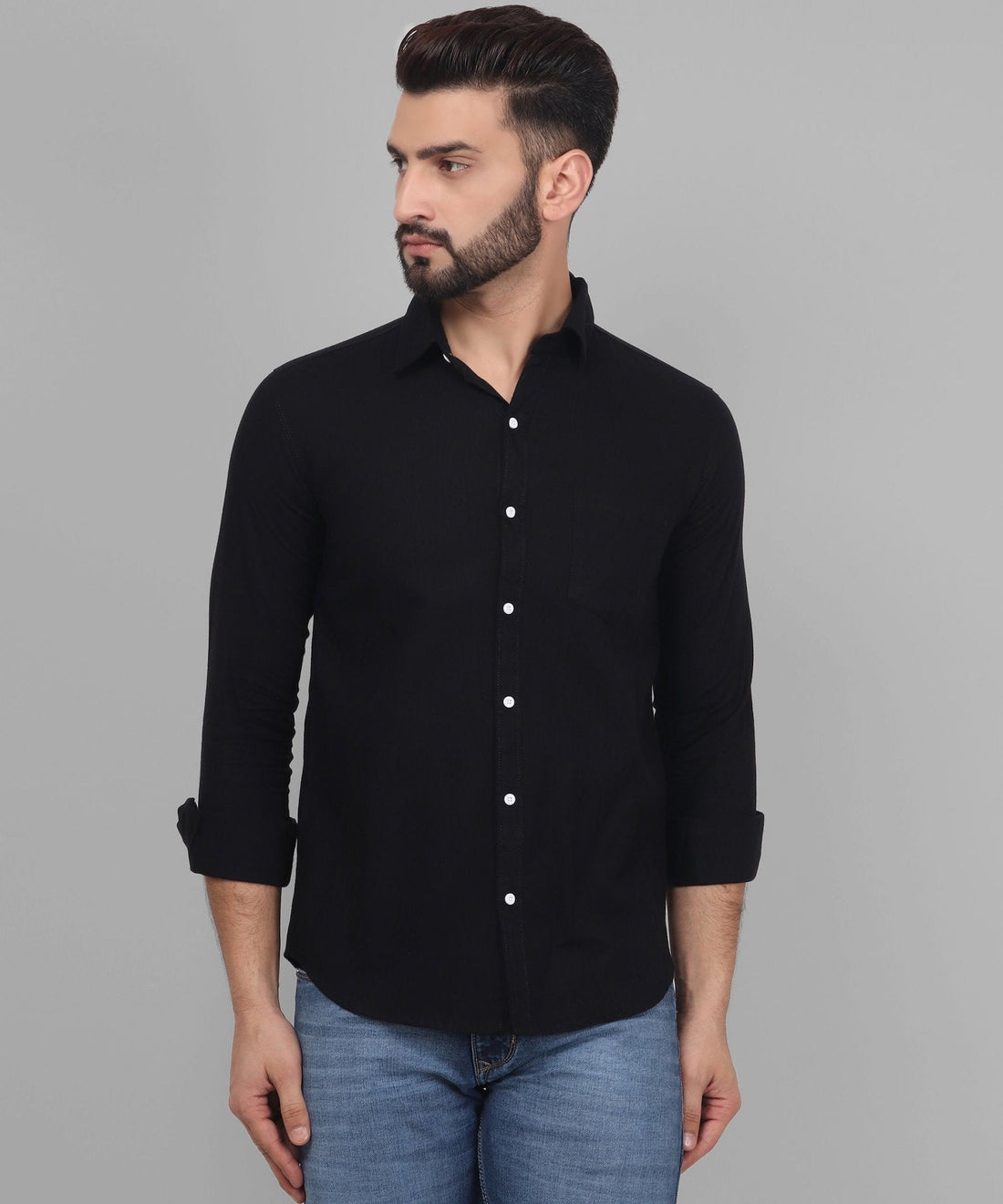 
a man wearing a black shirt and jeans
